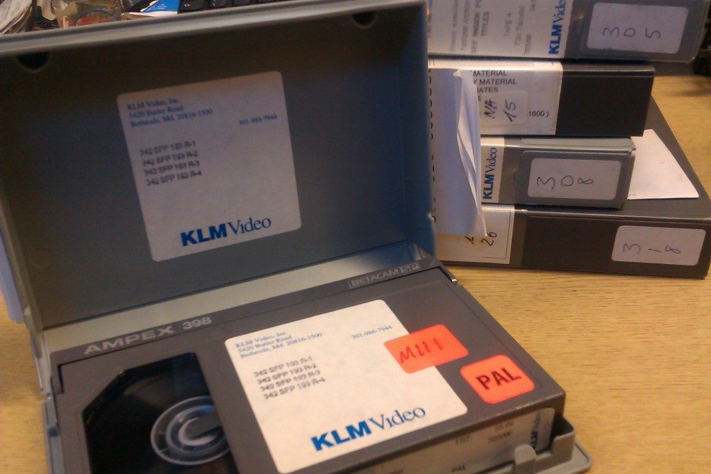 A Betacam SP tape in its case with the case open so you can see the contents. 