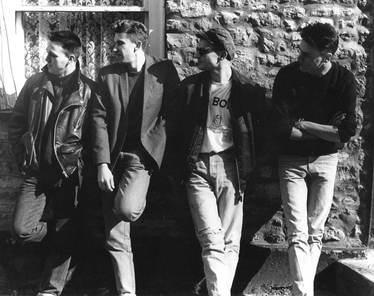 Four men (BOB) stand outside the cottage in Banwell