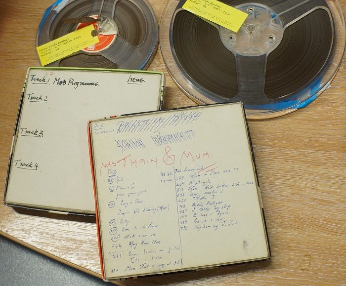 Two reel-to-reel tapes and boxes