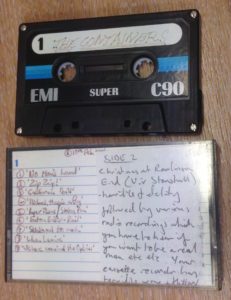 Audio cassette with case, songs listed in hand written text