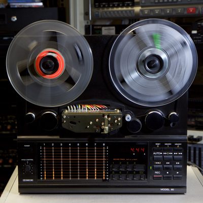reel-to-reel tape machine with clear plastic spools spinning
