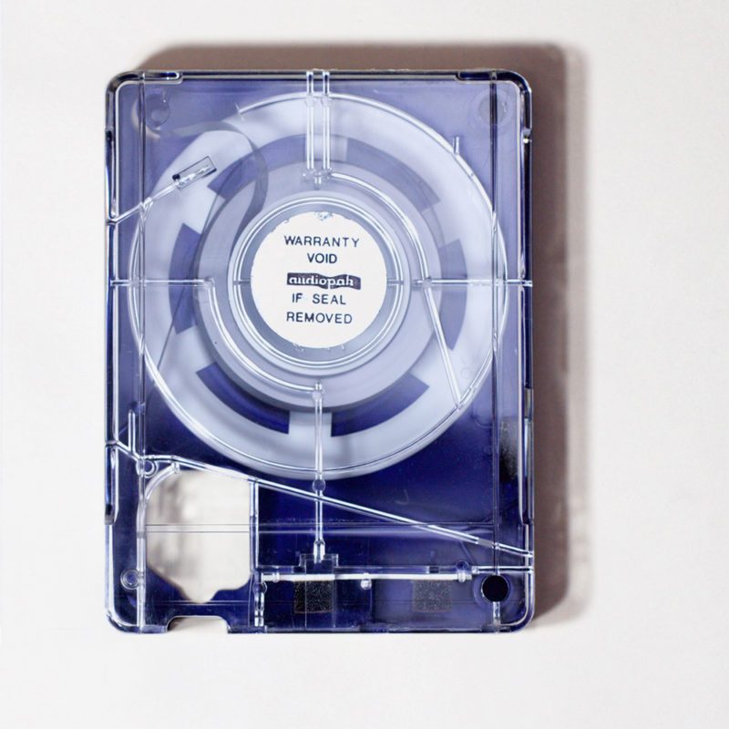 rectangular blue and clear plastic cartridge containing continuous loop of quarter inch tape