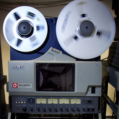 large upright Sony 1 inch video tape recorder with spools spinning