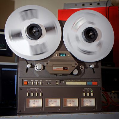 reel-to-reel tape machine with large aluminium spools spinning