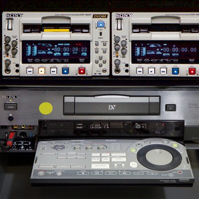 2 nearly identical cream-coloured DVCAM recorders, and brushed steel and grey rack-mounted DVCAM recorder with extended control panel with many buttons and large dial.