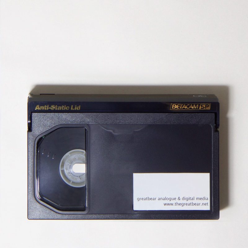 dark grey, rectangular plastic cassette, printed with text: Anti-Static Lid Betacam SP