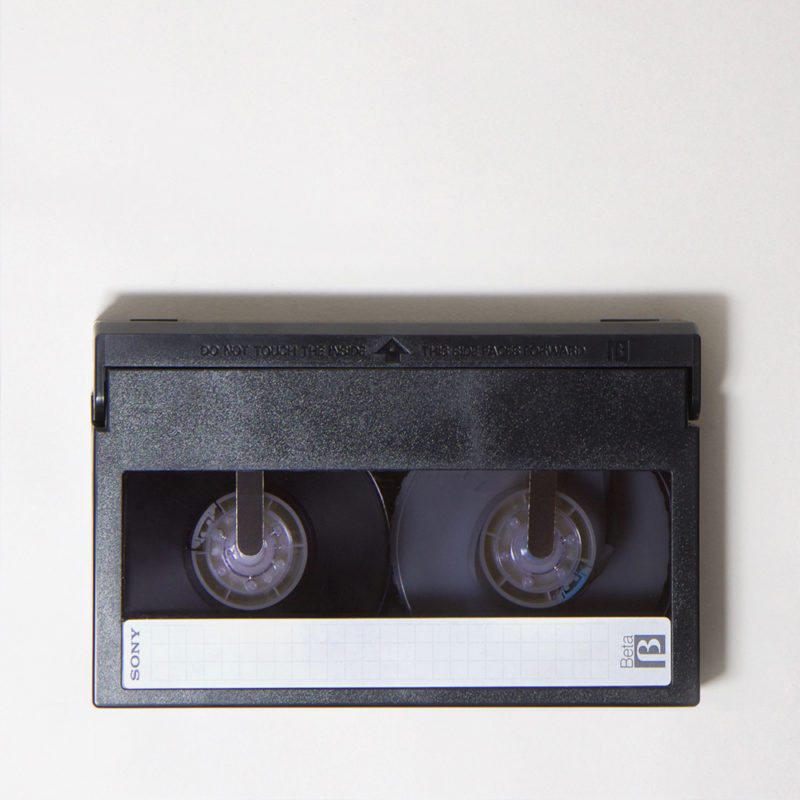 rectangular, dark grey, plastic video cassette