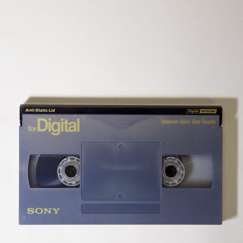 grey-blue, rectangular plastic cassette, printed with text: for Digital - Component Digital Video Cassette