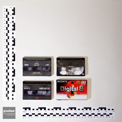4 rectangular plastic 8mm video cassettes with rulers indicating width 9.4 cm by height 6.1 cm