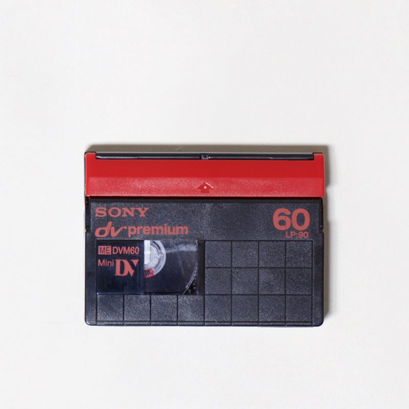 black and red rectangular plastic miniDV cassette