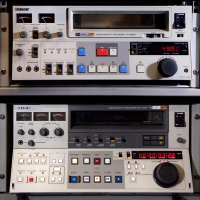2 large rack-mounted U-matic video recorders with multiple buttons, knobs and displays
