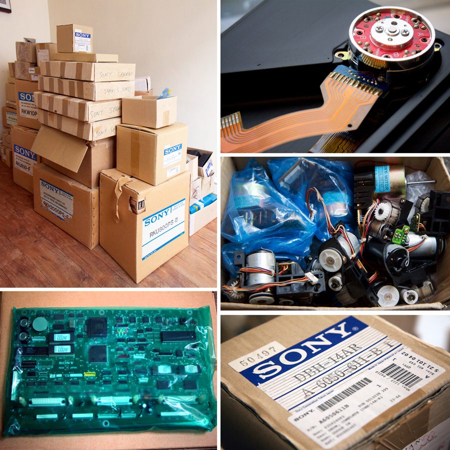 large stack of Sony-branded cardboard boxes various sizes; close up of electronic part; open box of mixed motors; Sony box labelled drum dbh14R; printed circuit board in green plastic